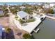 Aerial view of waterfront home with boat lift, gray roof, and lush landscaping with palm trees at 2805 N Beach Rd # B, Englewood, FL 34223