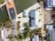 Aerial view of a house with gray roof and white gravel yard with a waterfront view next to a bridge at 2805 N Beach Rd # B, Englewood, FL 34223