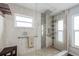Modern bathroom with glass-enclosed shower, neutral tiles, and a heated towel rack at 2805 N Beach Rd # B, Englewood, FL 34223