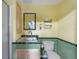 Bright bathroom features a unique design with retro colors and coordinated tile accents at 2805 N Beach Rd # B, Englewood, FL 34223