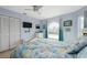 Light blue bedroom with a large window, closet and nautical decor create a serene space at 2805 N Beach Rd # B, Englewood, FL 34223