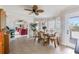 Dining area featuring tile floors, decorative walls, and views of the lanai and living room at 2805 N Beach Rd # B, Englewood, FL 34223