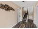 Welcoming foyer with tile flooring, staircase, and decorative fish art piece on the wall at 2805 N Beach Rd # B, Englewood, FL 34223