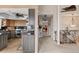 Hallway featuring an open staircase, views of a bright kitchen and living room at 2805 N Beach Rd # B, Englewood, FL 34223