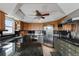 Eat-in kitchen featuring stainless appliances, dark countertops, and ample cabinet space at 2805 N Beach Rd # B, Englewood, FL 34223
