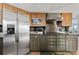 Gourmet kitchen featuring stainless appliances, dark countertops, and custom cabinetry at 2805 N Beach Rd # B, Englewood, FL 34223