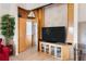 Living room featuring custom built-in media center with display shelves and an adjacent hidden door at 2805 N Beach Rd # B, Englewood, FL 34223