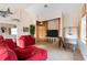 Bright living room featuring a red sofa, nautical decor, and staircase access at 2805 N Beach Rd # B, Englewood, FL 34223