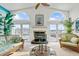 Cozy living room with a fireplace, arched windows, and comfortable seating with stunning water views at 2805 N Beach Rd # B, Englewood, FL 34223