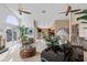 Open-concept living room with high ceilings, ceiling fans, a piano, and lots of natural light at 2805 N Beach Rd # B, Englewood, FL 34223