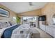 Bedroom with neutral walls, water view, and access to the outdoor patio at 2805 N Beach Rd # B, Englewood, FL 34223