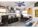 Office with built-in desk, ample shelving, and natural light from the windows at 2805 N Beach Rd # B, Englewood, FL 34223