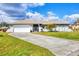 Charming single-story home with a well-manicured lawn and an attached two-car garage at 3522 Fox Ter, Port Charlotte, FL 33981