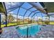 Inviting screened-in pool area with clear blue water, providing a perfect space for relaxation at 3522 Fox Ter, Port Charlotte, FL 33981