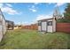 Backyard with a shed and a view of the screened in pool area at 4204 Cockrell St, Port Charlotte, FL 33948