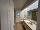 A bathroom with a large mirror, tile floors, and a combined shower and tub at 4204 Cockrell St, Port Charlotte, FL 33948