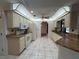 Classic kitchen featuring white cabinetry, granite countertops, and tile flooring at 4204 Cockrell St, Port Charlotte, FL 33948