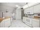 Bright kitchen featuring white cabinetry, tile flooring, and breakfast bar at 4204 Cockrell St, Port Charlotte, FL 33948