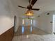 Cozy living room featuring tile flooring, wood paneling, and ceiling fans at 4204 Cockrell St, Port Charlotte, FL 33948