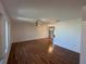 Spacious living room with wood flooring, bright windows, and ceiling fan at 4204 Cockrell St, Port Charlotte, FL 33948