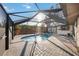 A screened-in pool area featuring a round pool and brick pavers at 4204 Cockrell St, Port Charlotte, FL 33948