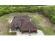 Expansive home featuring a screened pool, manicured lawn and paver driveway offering elegance and privacy at 10451 Hatchett Cir, Port Charlotte, FL 33981