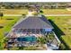 Gorgeous home showcasing a screened-in pool and patio, enhanced by lush landscaping and a charming white fence at 1061 Boundary Blvd, Rotonda West, FL 33947