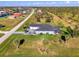 Stunning aerial view of a beautifully landscaped home with a screened-in pool at 1061 Boundary Blvd, Rotonda West, FL 33947