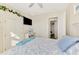 Lovely bedroom showcasing a ceiling fan, television, shutters, and a coastal theme at 1061 Boundary Blvd, Rotonda West, FL 33947