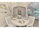 Dining room boasts an elegant chandelier, seating for six, and views of the pool at 1061 Boundary Blvd, Rotonda West, FL 33947