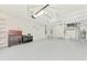 Spacious garage with high ceilings, painted floor, a variety of storage and shelving at 1061 Boundary Blvd, Rotonda West, FL 33947