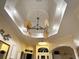 Elegant living room features tray ceilings, custom lighting, and an open floor plan at 1061 Boundary Blvd, Rotonda West, FL 33947
