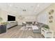Spacious living room with neutral walls features a large sectional and entertainment center at 1061 Boundary Blvd, Rotonda West, FL 33947