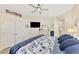 Bright main bedroom boasts coastal decor, ceiling fan, TV, dresser, and closet at 1061 Boundary Blvd, Rotonda West, FL 33947