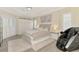 Elegant main bedroom features a tray ceiling, large bed and built-in wardrobe at 1061 Boundary Blvd, Rotonda West, FL 33947