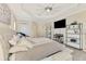 Bright main bedroom boasts neutral walls, a tray ceiling, fan and display shelving at 1061 Boundary Blvd, Rotonda West, FL 33947