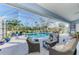 Inviting screened patio with pool, comfortable seating, and a beautiful view of the landscape at 1061 Boundary Blvd, Rotonda West, FL 33947