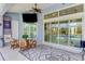 Charming covered patio with comfortable seating, scenic views, and an outdoor ceiling fan at 1061 Boundary Blvd, Rotonda West, FL 33947