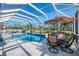 Inviting screened pool area featuring dining and lounging spaces for ultimate outdoor enjoyment at 1061 Boundary Blvd, Rotonda West, FL 33947