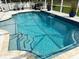 Clear blue pool with mosaic tile accents and convenient, decorative steps at 1061 Boundary Blvd, Rotonda West, FL 33947
