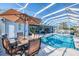 Beautiful, screened-in pool area with outdoor dining and clear blue water at 1061 Boundary Blvd, Rotonda West, FL 33947