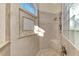 Stylish shower showcases a built-in bench, stone tile and glass block window at 1061 Boundary Blvd, Rotonda West, FL 33947