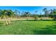 Lush, green lawn dotted with palm trees, offering a serene outdoor space at 1061 Boundary Blvd, Rotonda West, FL 33947