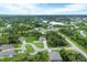 Aerial view of a single Gathering home that is surrounded by lush greenery in a residential neighborhood at 108 Wagon Place, Rotonda West, FL 33947