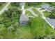 Aerial view of a home with a pool in the screened in lanai, and lush landscaping in the neighborhood at 108 Wagon Place, Rotonda West, FL 33947