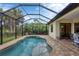 Backyard pool and screened patio with a private backyard at 108 Wagon Place, Rotonda West, FL 33947