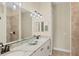 This dual sink bathroom has granite countertops and modern lighting fixtures at 108 Wagon Place, Rotonda West, FL 33947
