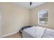 Bright bedroom with neutral walls, window view, and ceiling fan at 108 Wagon Place, Rotonda West, FL 33947