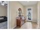 Inviting entryway with a wooden dresser, round mirror and decorative accents at 108 Wagon Place, Rotonda West, FL 33947