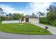 Charming one-story home with a well-kept lawn, attached two-car garage, and manicured landscaping at 108 Wagon Place, Rotonda West, FL 33947